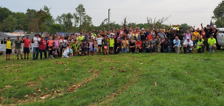 A large volunteer group gathers for a photo after a cleanup day