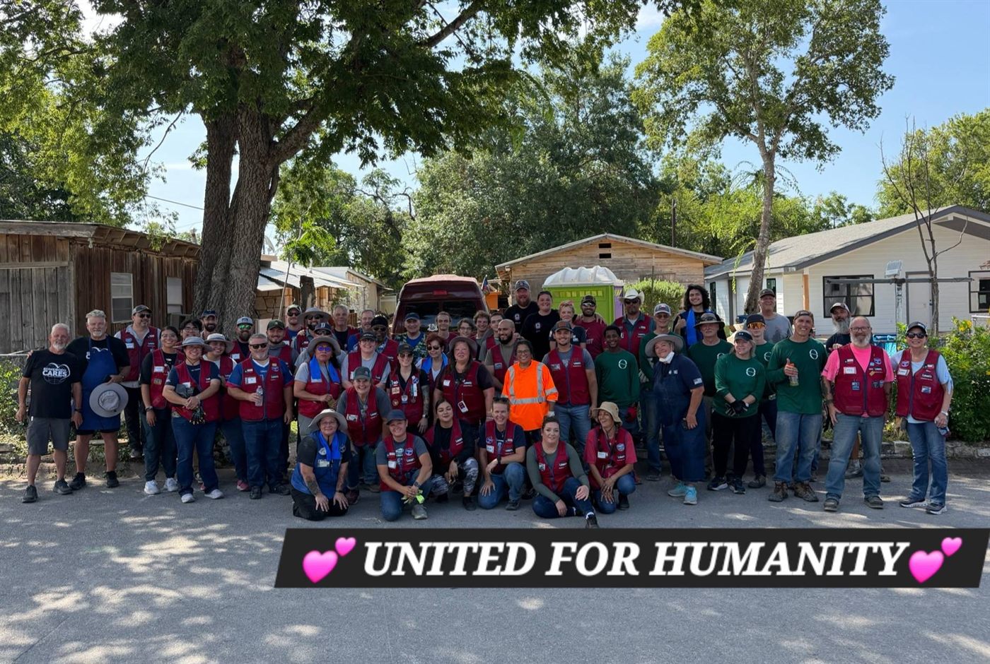 Volunteers from partner organizations gather after a community cleanup day: United for Humanity